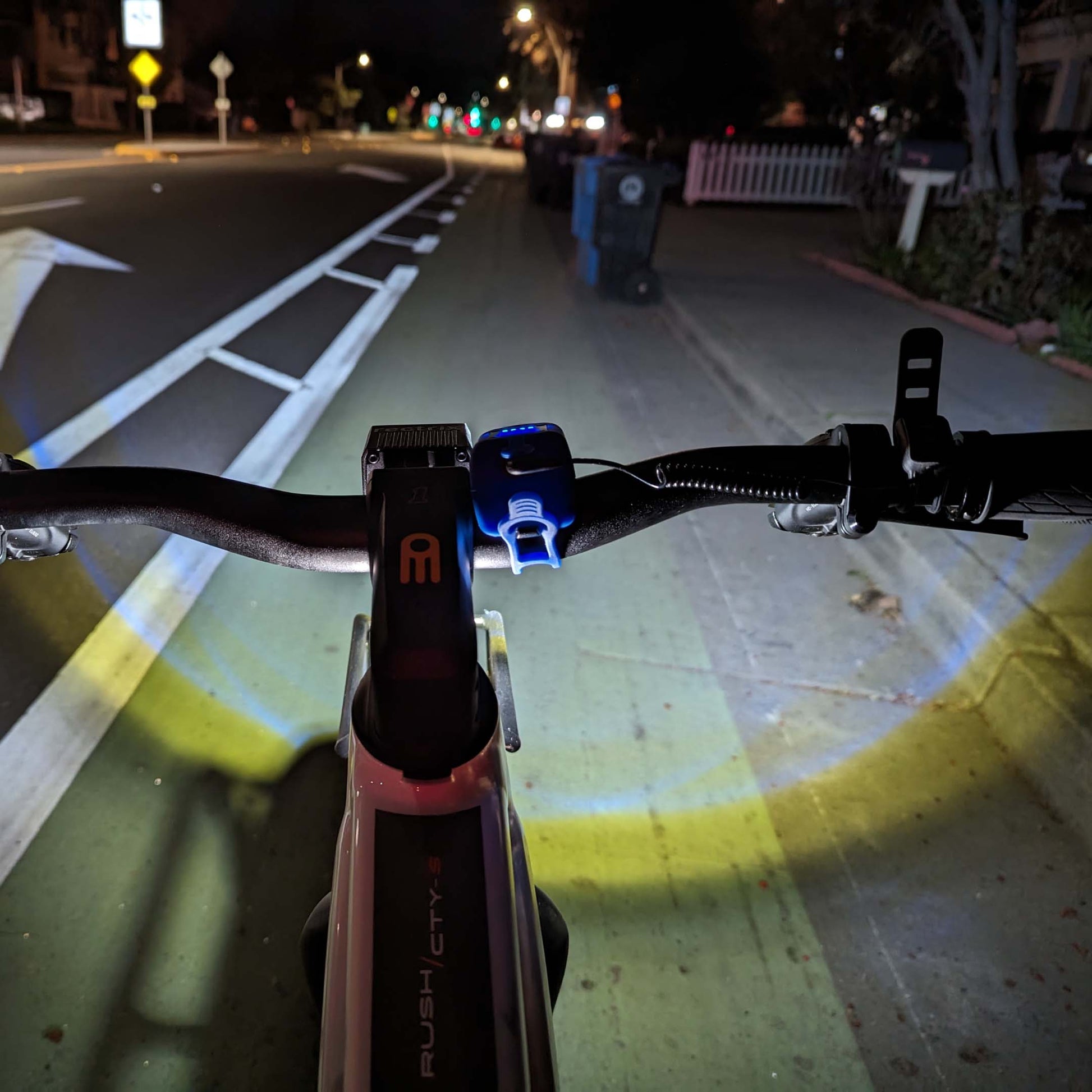 POV of the product's brightness on a dark bike lane at night