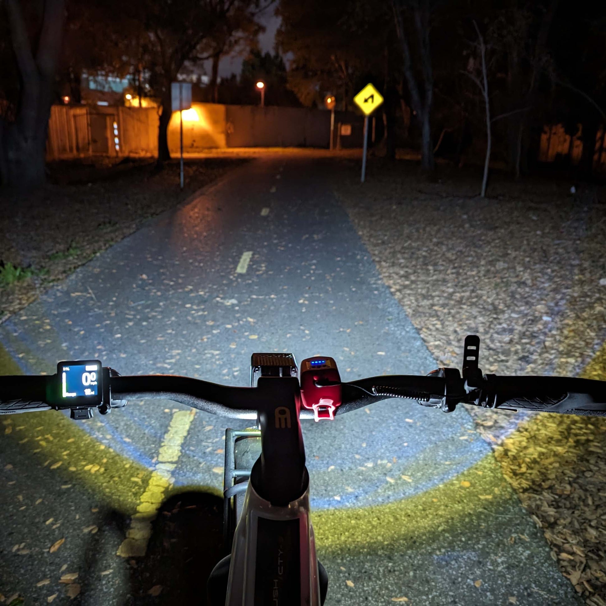 POV of the product's brightness on a dark bike path at night